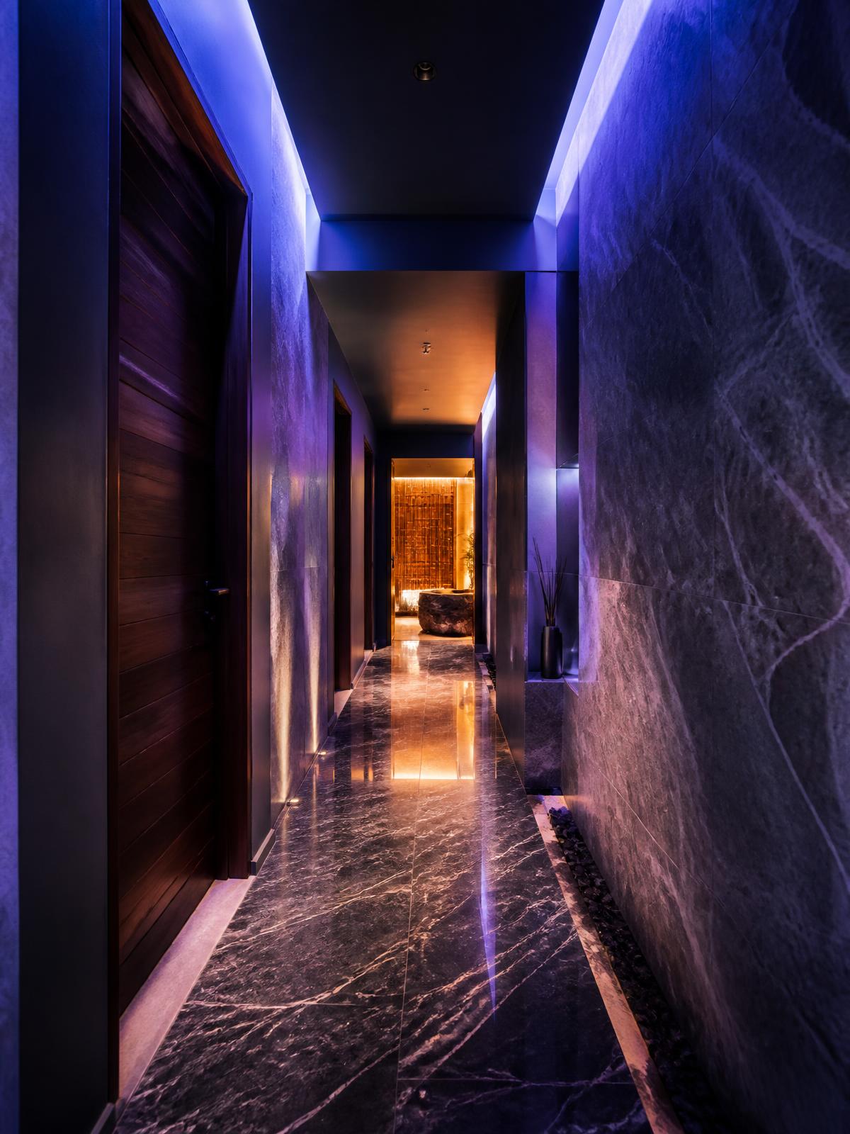 Ambient lit corridor leading to the treatment rooms